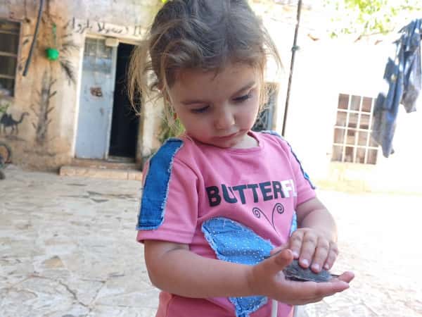 In the crowd of pain... Fatina still paints hope.