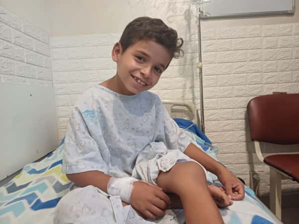 On the uneven floor of their tent, a needle found its way into Amir's knee and is causing him severe pain!
