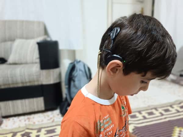A child suffering from hearing loss.