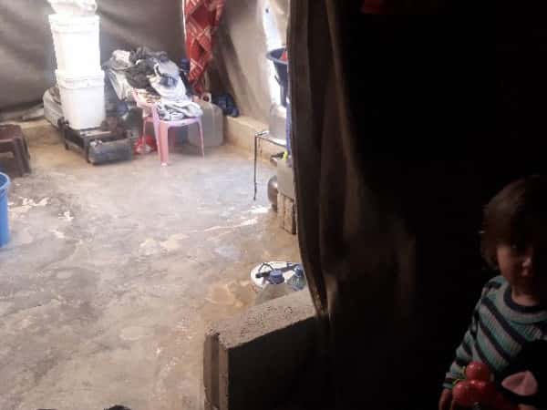 Family living in an inhabitable tent
