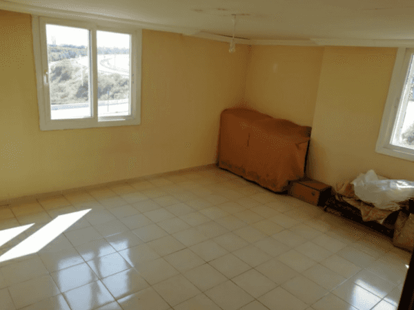 A family suffers in an almost empty house.