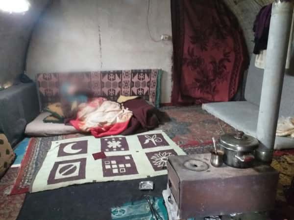 A disabled woman living in a poor tent
