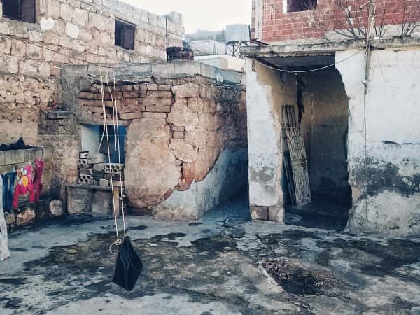 A displaced family living in a house that looks like a tent!