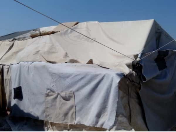 A widow living with her daughter in a tent without a breadwinner