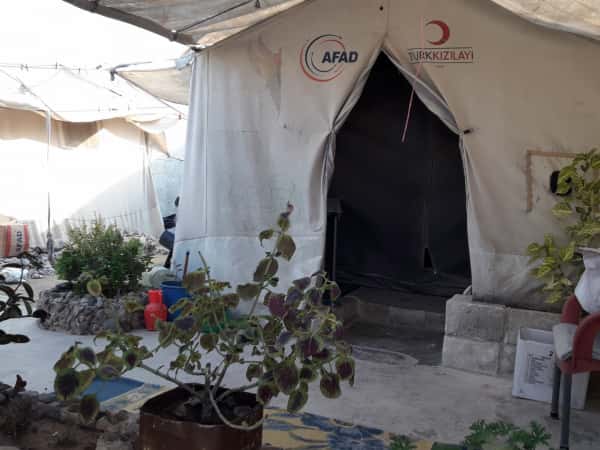 A lady waiting for her child in a tent!
