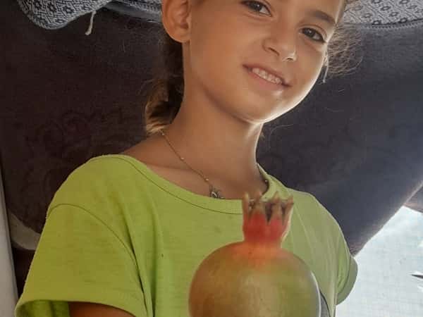 Mask's Silent Cry: Comfort an Orphaned Child in Gaza