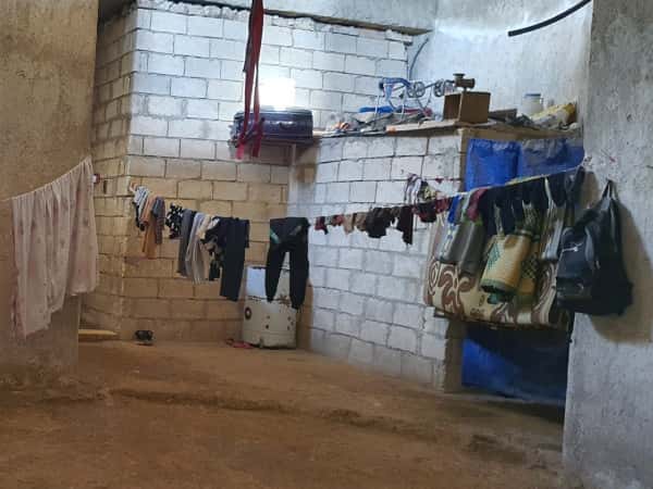 A family lives in an uninhabitable house without electricity