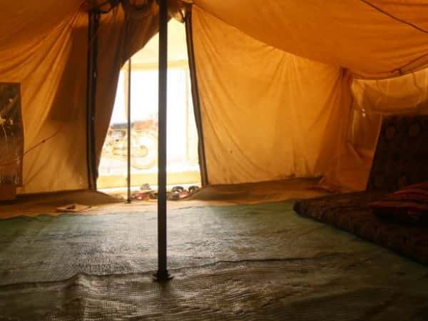An elderly woman lives in a tent!