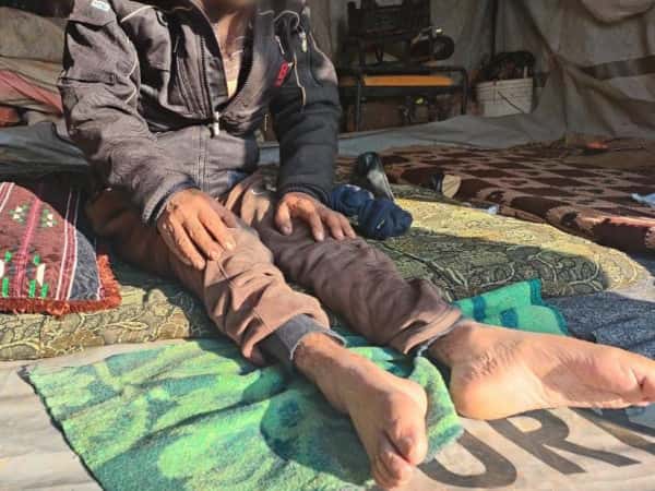 A family beneath a roof that offers no shelter.
