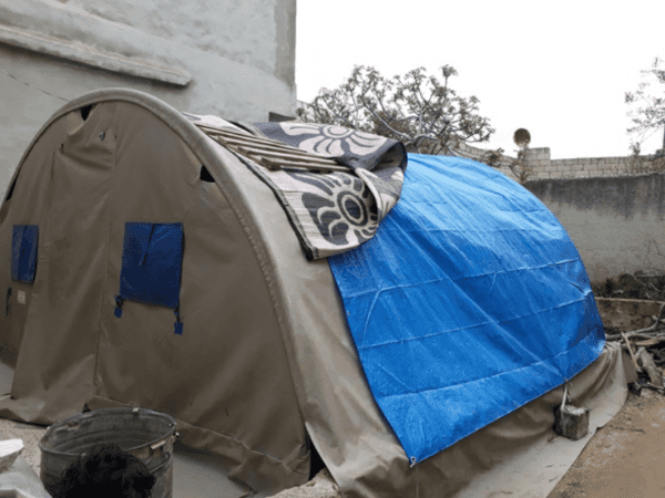 A family lives in a room and a tent!